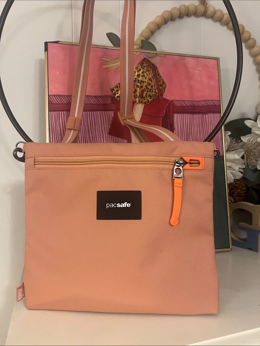 Pacsafe Peach Crossbody Bag with Orange Zipper Pull